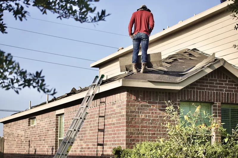 Professional roofer working on a residential roof in Stoneybrook